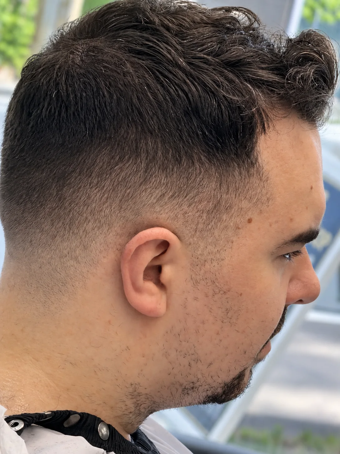 Side profile of a finished short fade at JR Barbershop
