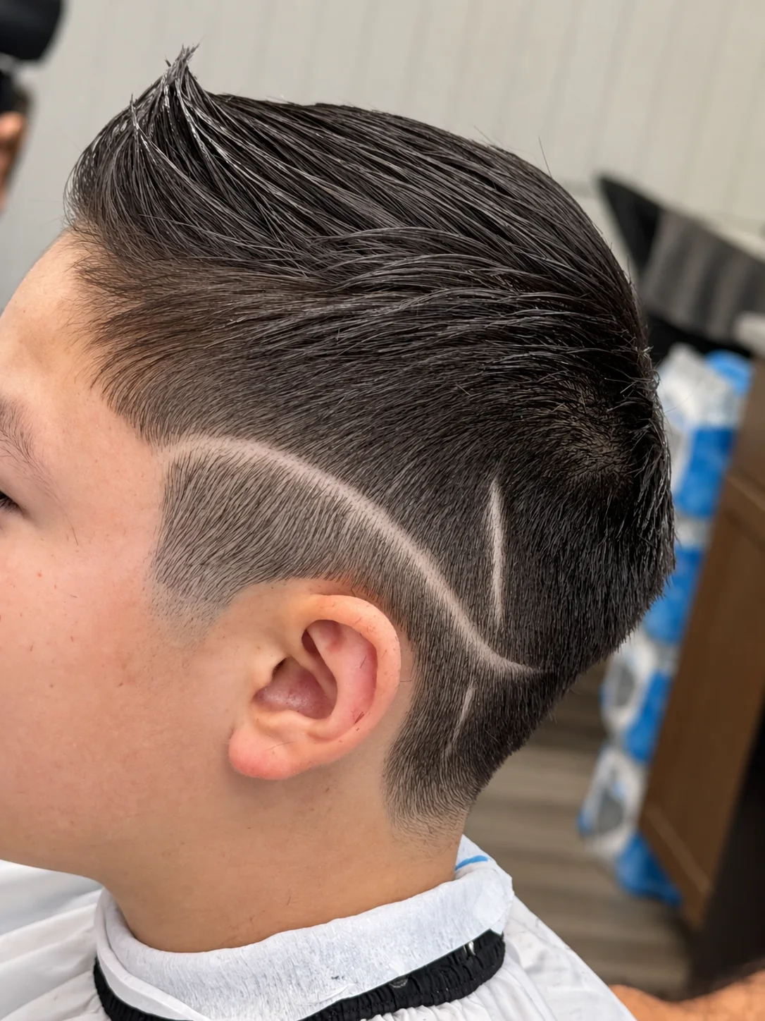 Close view of a finished haircut with a shaved line design