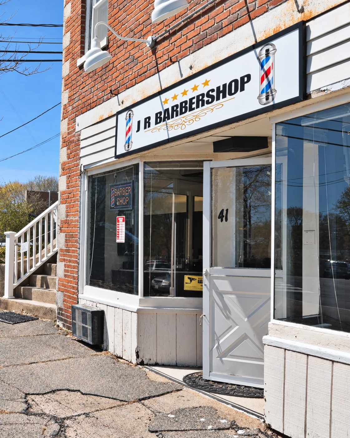 JR Barbershop sign and open entrance on Central Ave