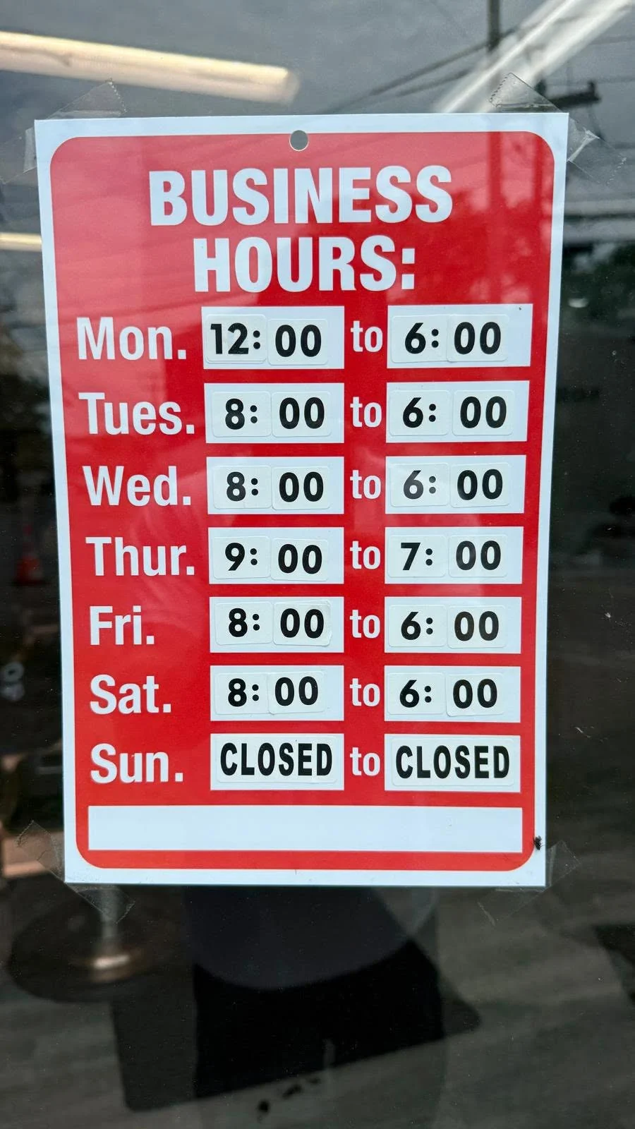 JR Barbershop window sign listing regular business hours